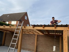 Roof 30% installed, using string to align bolts